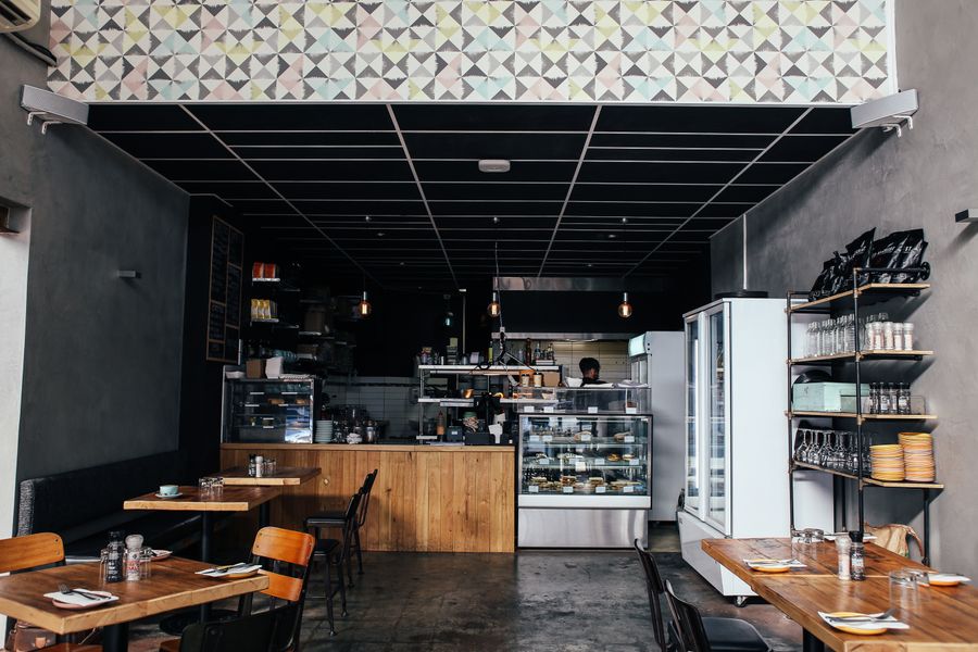 Warm café interior with wooden tables and counter