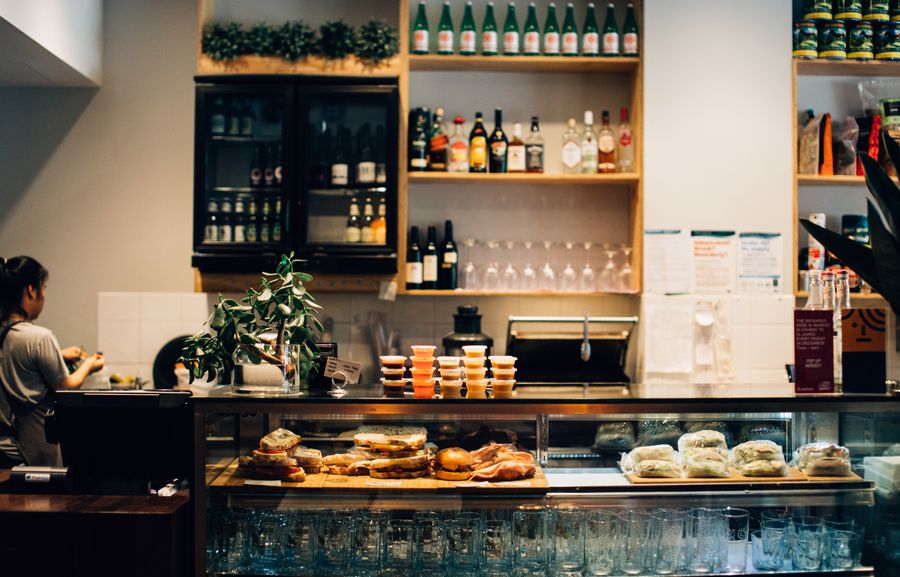 Deli counter display case with fresh sandwiches and ingredients