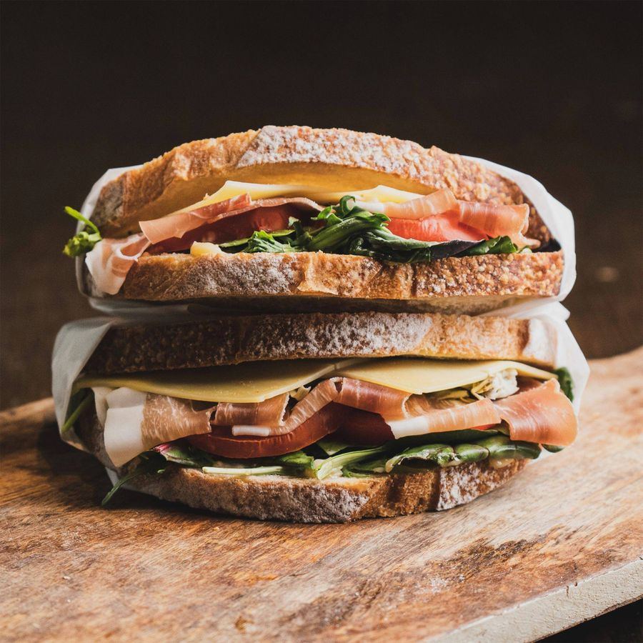 Gardena Italian sandwich stacked with prosciutto, provolone, tomato and arugula